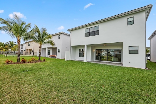 back of property featuring a lawn