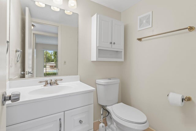 bathroom featuring vanity and toilet