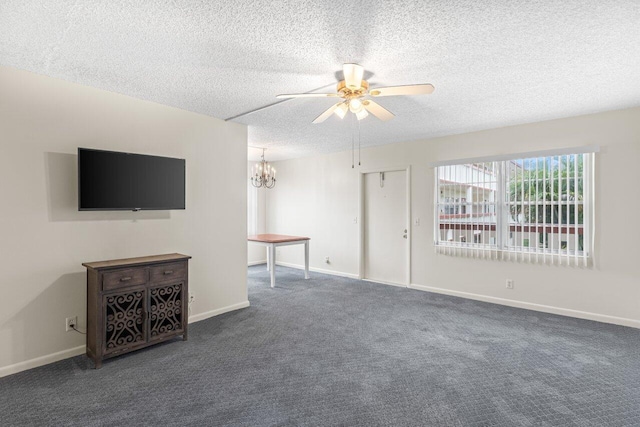 unfurnished living room with ceiling fan, dark carpet, and a textured ceiling