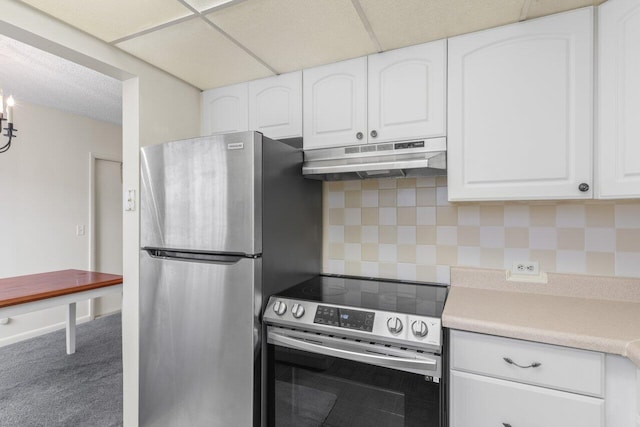 kitchen featuring carpet floors, white cabinets, backsplash, stainless steel appliances, and a drop ceiling