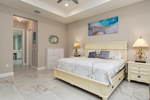 bedroom featuring a tray ceiling and ceiling fan