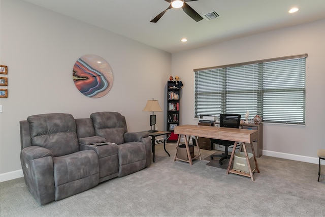 carpeted office space featuring ceiling fan