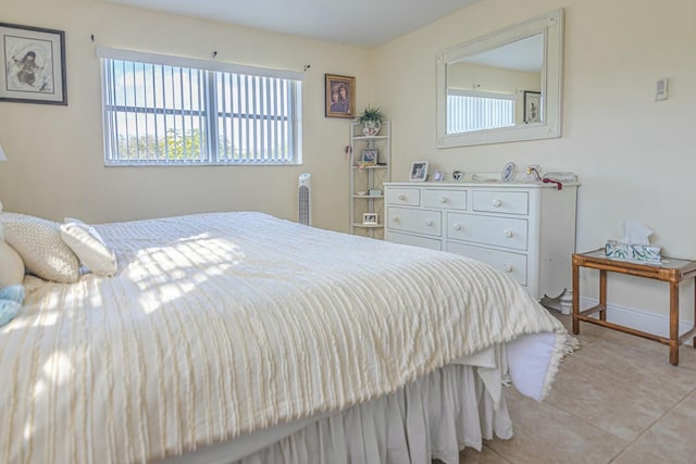 bedroom with light tile patterned floors