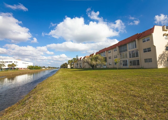 exterior space with a yard and a water view