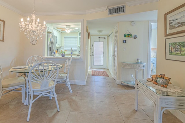 dining room with crown molding and light tile patterned floors