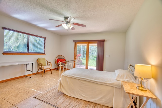 bedroom with baseboards, a textured ceiling, ceiling fan, and access to outside