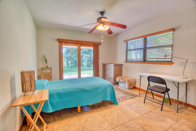 bedroom featuring tile patterned flooring, access to outside, baseboards, and a textured ceiling