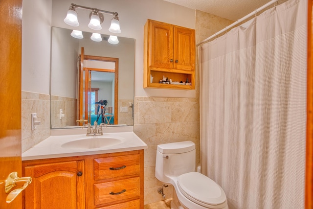 bathroom featuring a wainscoted wall, toilet, a shower with shower curtain, tile walls, and vanity