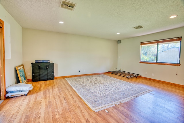 interior space featuring recessed lighting, visible vents, baseboards, and wood finished floors