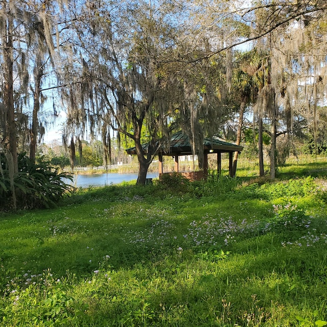 view of yard with a gazebo and a water view