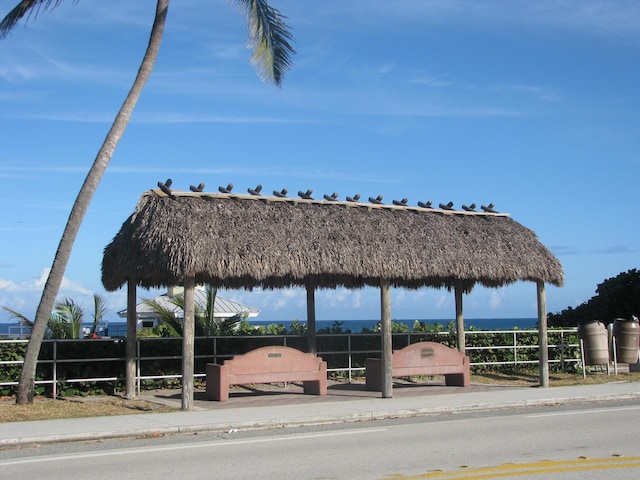 view of home's community featuring a water view and fence