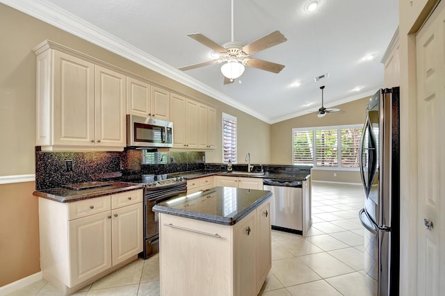 kitchen featuring a center island, vaulted ceiling, dark stone counters, kitchen peninsula, and stainless steel appliances