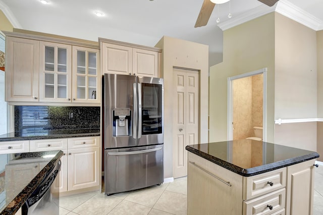 kitchen featuring dark stone countertops, a center island, light tile patterned floors, and stainless steel fridge with ice dispenser