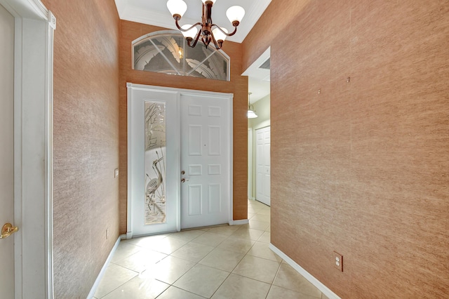 entrance foyer with light tile patterned flooring, a towering ceiling, crown molding, and an inviting chandelier