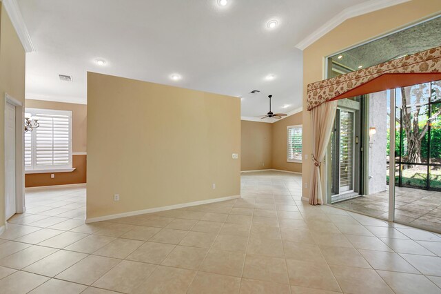 empty room featuring lofted ceiling, light tile patterned floors, and ornamental molding