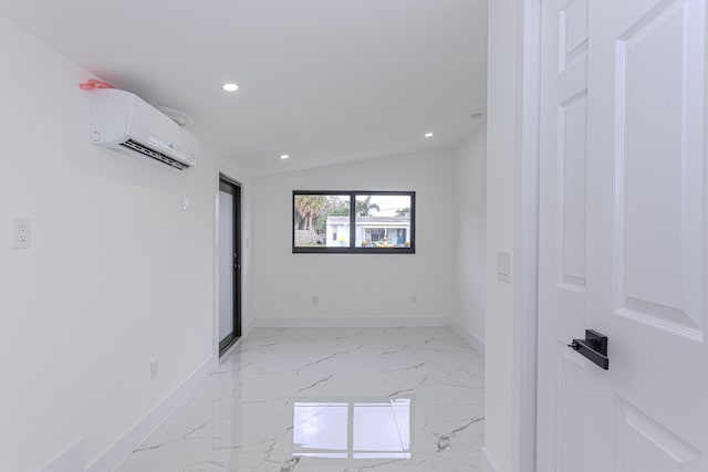 spare room featuring vaulted ceiling and an AC wall unit