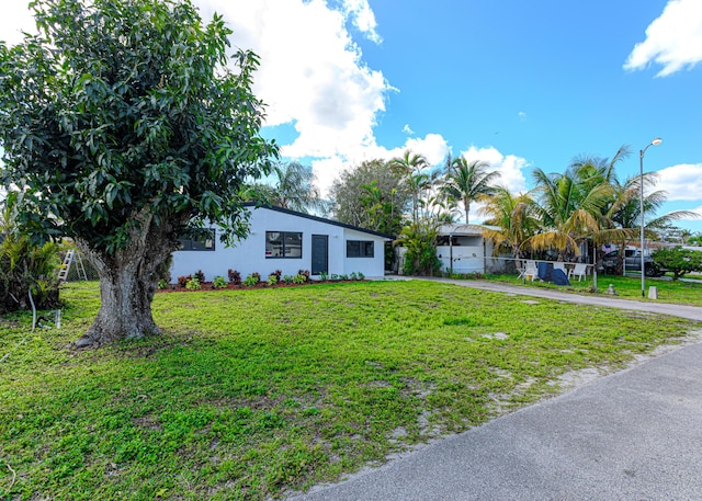 ranch-style house with a front lawn