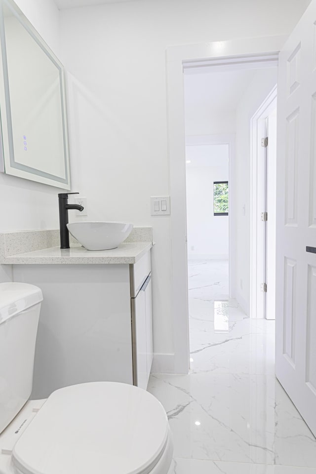 bathroom featuring vanity and toilet