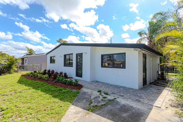 view of front of property with a patio area and a front yard