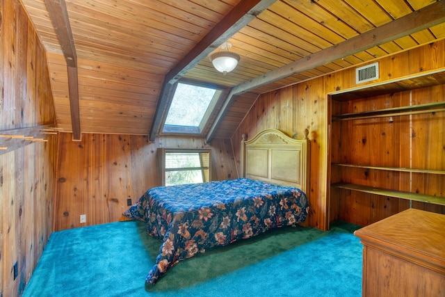 bedroom featuring wooden walls, visible vents, vaulted ceiling with skylight, wooden ceiling, and carpet flooring