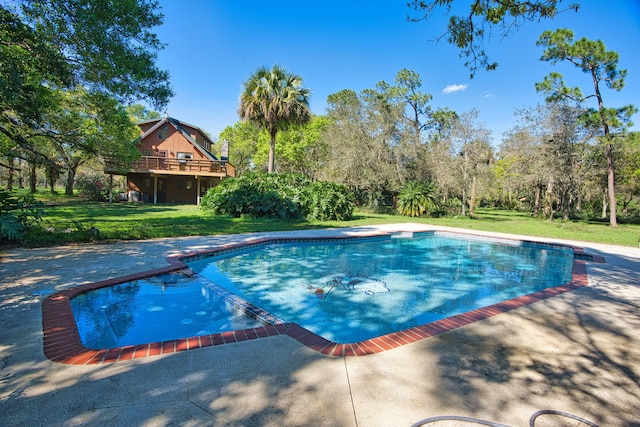 pool with a wooden deck and a yard