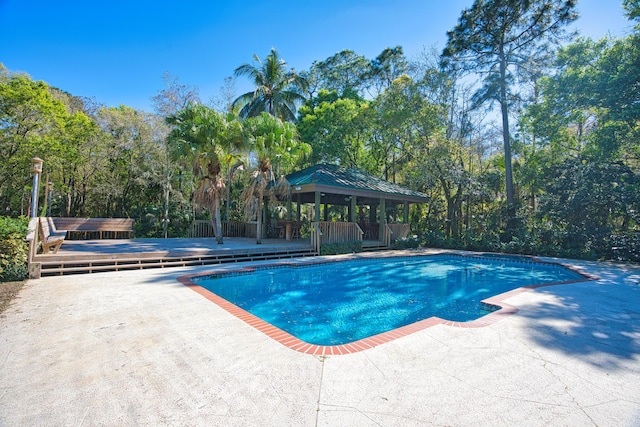 pool featuring a gazebo, a patio area, and a wooden deck