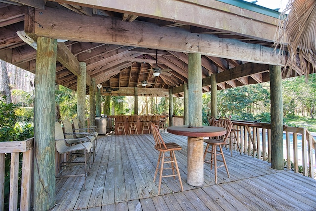 deck featuring a gazebo, outdoor dining space, and ceiling fan