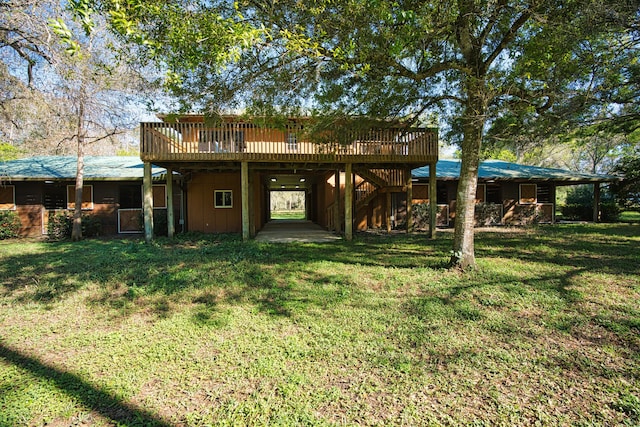 back of house with a wooden deck, a lawn, and stairway