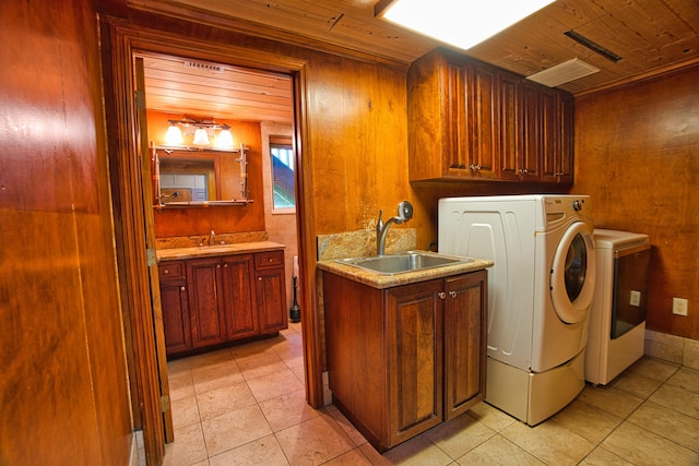 laundry area with light tile patterned flooring, cabinet space, wooden ceiling, and a sink