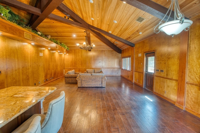 unfurnished living room with visible vents, vaulted ceiling with beams, wood ceiling, hardwood / wood-style floors, and a notable chandelier