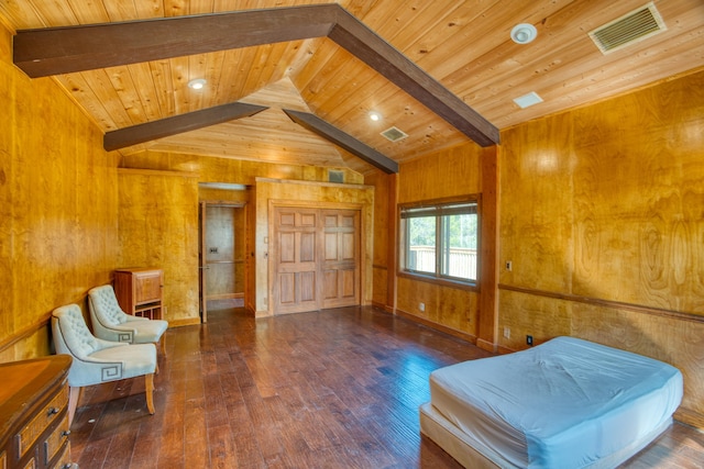 living area with visible vents, wood walls, vaulted ceiling with beams, and wood-type flooring