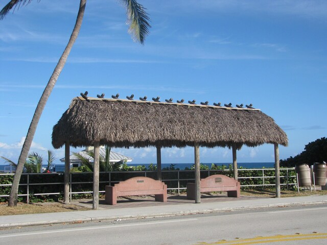 view of property's community featuring a water view and fence