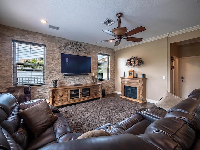 living room with hardwood / wood-style floors, crown molding, a textured ceiling, and ceiling fan