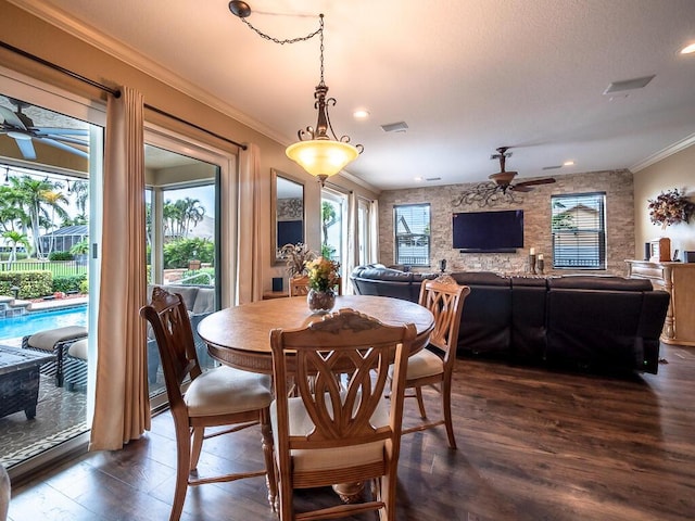 dining area featuring crown molding, dark hardwood / wood-style floors, and ceiling fan