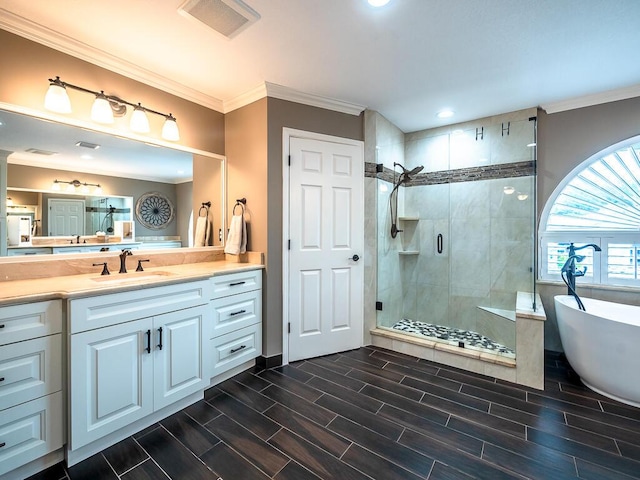 bathroom featuring vanity, ornamental molding, and plus walk in shower