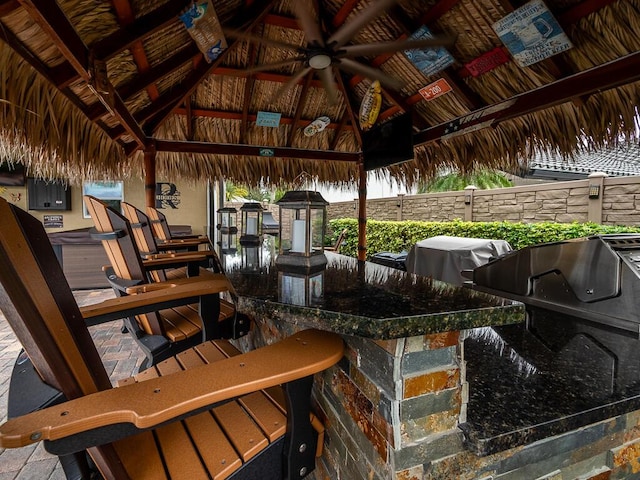 view of patio / terrace with a gazebo, area for grilling, an outdoor bar, and ceiling fan