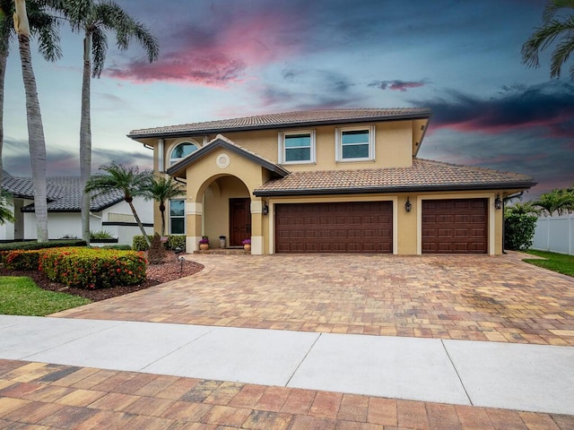 mediterranean / spanish-style home featuring a garage