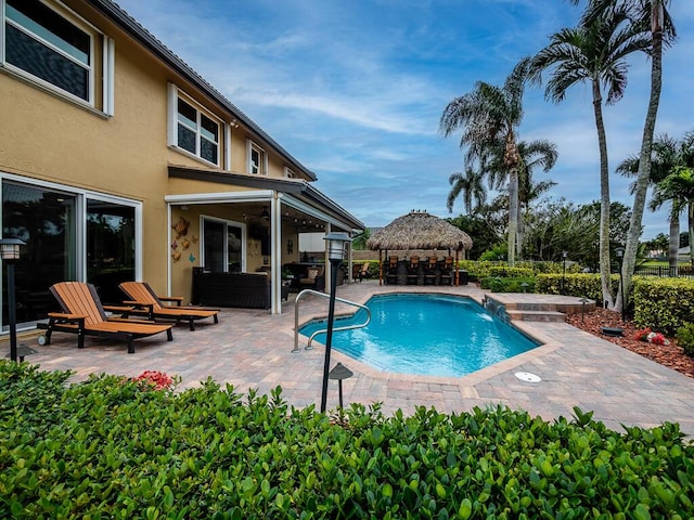 view of pool with a gazebo, an outdoor living space, and a patio