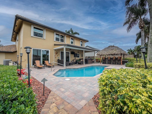 view of swimming pool with an outdoor bar, cooling unit, a gazebo, outdoor lounge area, and a patio area