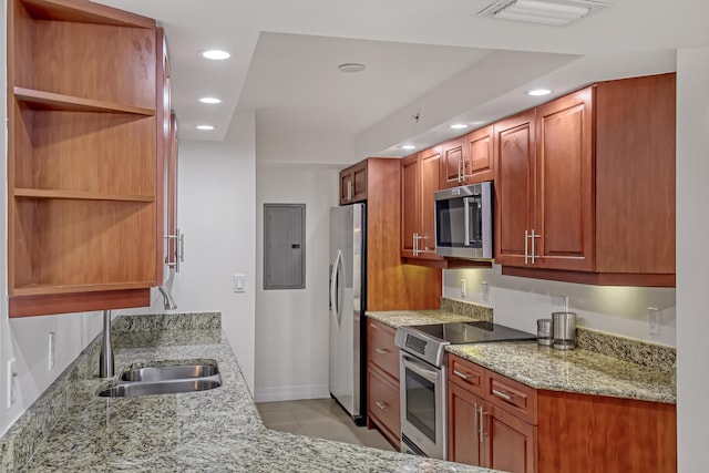 kitchen featuring sink, light tile patterned floors, appliances with stainless steel finishes, electric panel, and light stone countertops