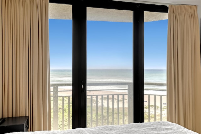 unfurnished bedroom with a water view and a beach view