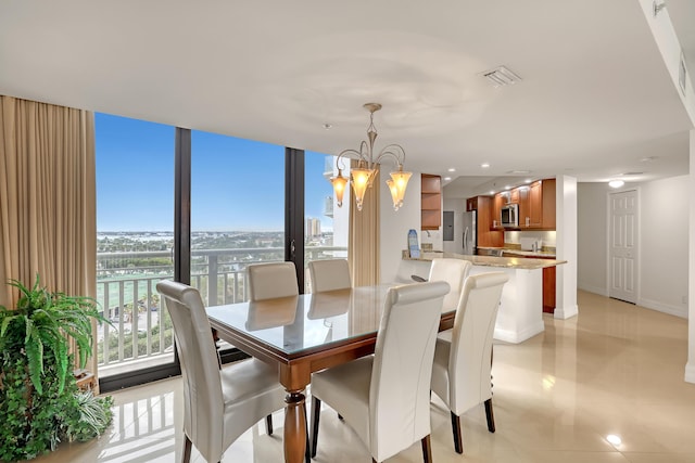 dining area with expansive windows, light tile patterned flooring, a healthy amount of sunlight, and a notable chandelier