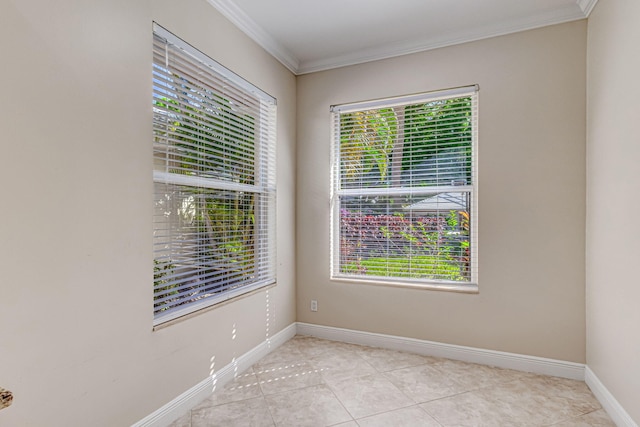 unfurnished room with ornamental molding and light tile patterned floors