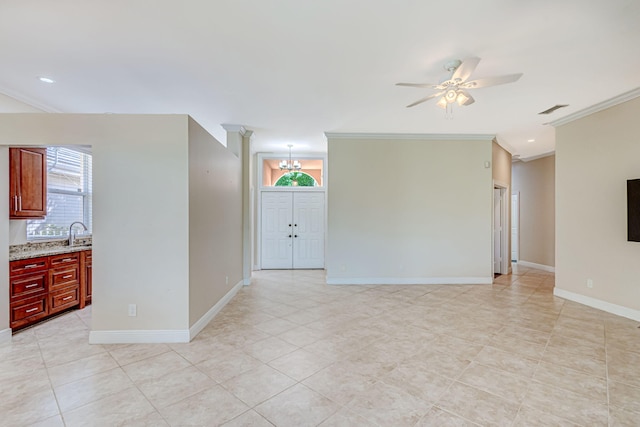 tiled empty room with crown molding, sink, and ceiling fan with notable chandelier