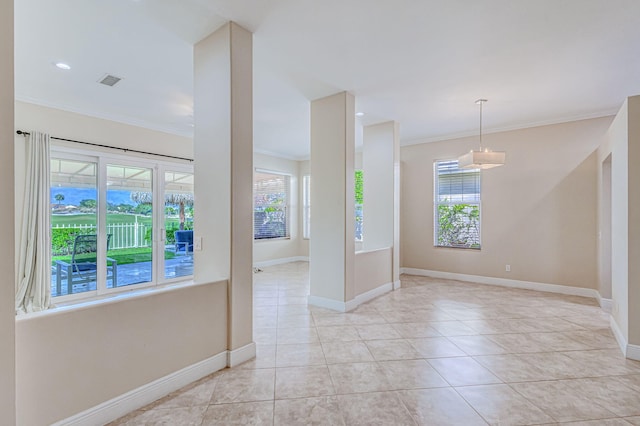 spare room featuring ornamental molding, a healthy amount of sunlight, and light tile patterned flooring