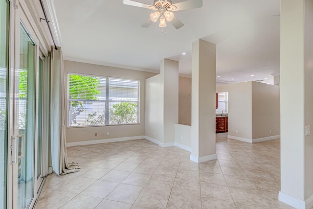 tiled spare room with ornamental molding and ceiling fan