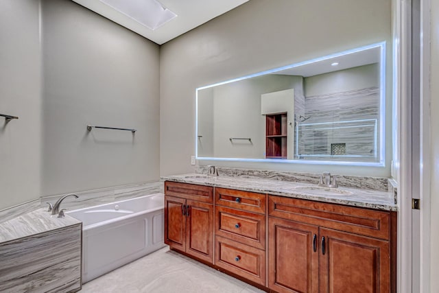 bathroom with vanity and shower with separate bathtub