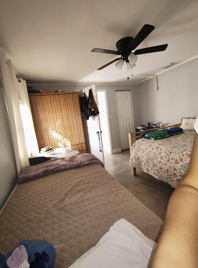 tiled bedroom with ceiling fan