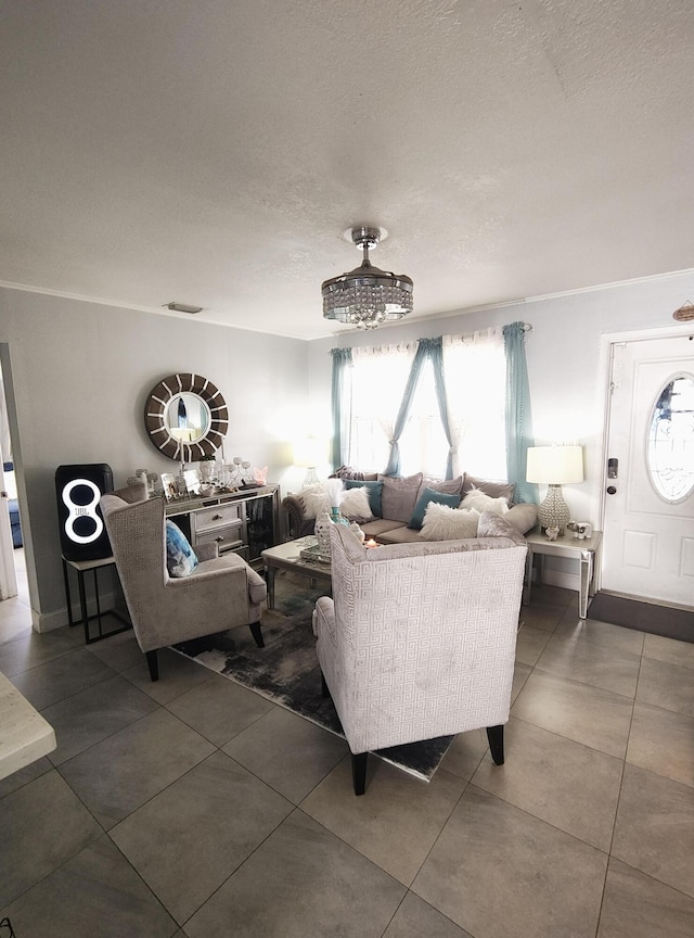 tiled living room with ornamental molding and a textured ceiling