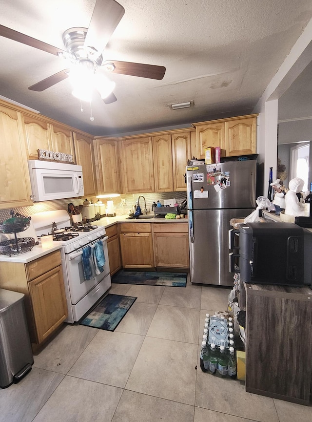 kitchen with white appliances, sink, decorative backsplash, and light tile patterned floors